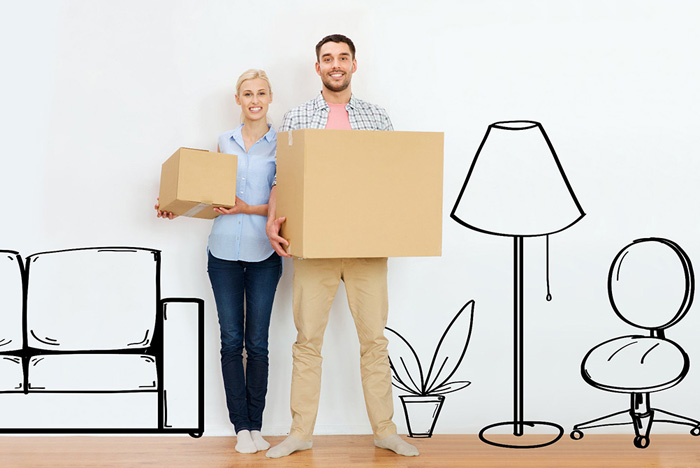 Bien emballer ses affaires pour déménager : Un couple qui tient un carton de déménagment